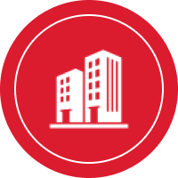 White building icon on a red circular background.